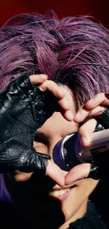 Singer with purple hair and gloves creating heart shape on stage.