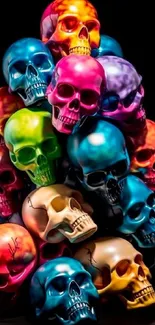 Colorful piled skulls on a dark background.