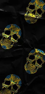 Vibrant yellow and blue skulls on dark wallpaper background.