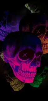 Vibrant neon skulls on a dark background mobile wallpaper.