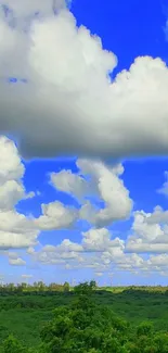 Beautiful landscape with blue sky and clouds over green scenery.