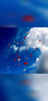 Red and white balloons floating against a blue sky with clouds.