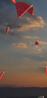 Floating watermelon slices against a sunset sky wallpaper.