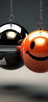 Orange and black glossy smiley face spheres hanging on chains.