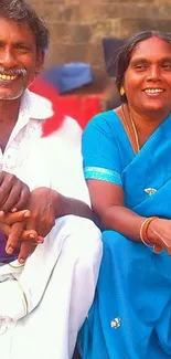 A vibrant portrait of a smiling couple in traditional blue attire.