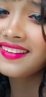 Close-up of a smiling person with vibrant pink lips.