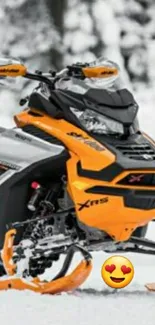 Orange snowmobile in snowy landscape.