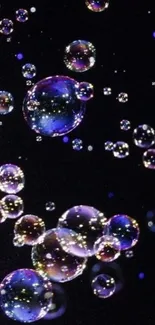 Colorful soap bubbles float against a black background in this mobile wallpaper.