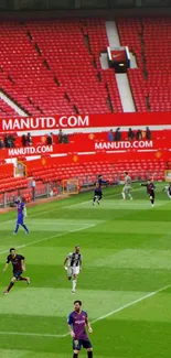 Soccer players in action in a red stadium.