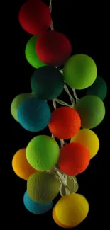 Vibrant neon spheres against a stark black background, glowing in multiple bright colors.