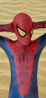 Spider hero poses on sandy background wallpaper.