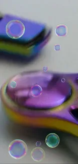 Colorful purple fidget spinner with bubbles on a mobile wallpaper.