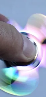 Colorful spinner in motion against a light gray background.