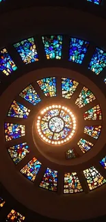 Spiral stained glass art with vibrant blue hues.