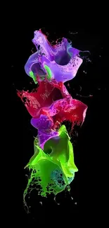 Colorful splash of paint on black background wallpaper.