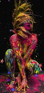 A colorful splatter art wallpaper with neon paint on a black background.