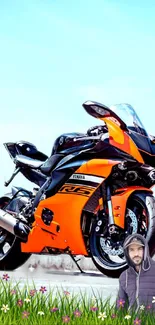 Vibrant orange sport bike under clear sky.