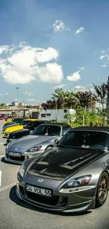 Lineup of sleek sports cars under a blue sky.