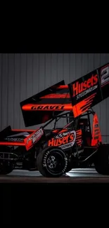 Sprint car with orange highlights against a metallic background.