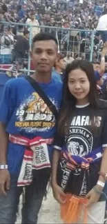 Fans at a crowded stadium event, showcasing team colors.