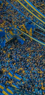 Vibrant blue and yellow stadium crowd with flags.