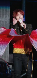 Dynamic stage performance with vibrant colors and a red-themed costume.