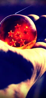 Amber star orb held in hand, glowing vibrantly against a dark background.