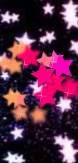 Colorful stars wallpaper with pink and orange stars on a dark background.