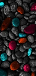 Colorful pebbles on a dark textured stone background wallpaper.