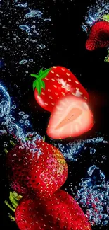 Juicy strawberries splashing in water with a vibrant black background.