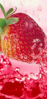 Juicy strawberry splashing in pink water wallpaper.