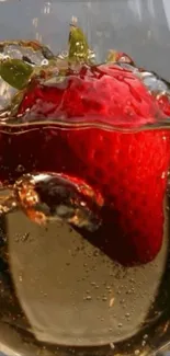 A vibrant strawberry submerged in bubbling liquid.