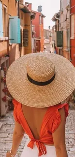 Woman in stylish outfit on a European street with colorful buildings.