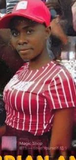 Woman in red-striped shirt with urban street art background.