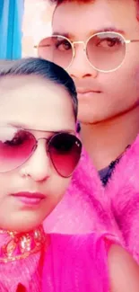 Stylish duo with sunglasses in vibrant pink fashion.