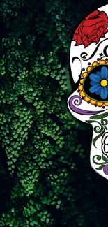 Colorful sugar skull with green leaves backdrop.