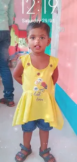 Young girl in yellow dress with colorful background.