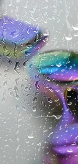 Colorful sunglasses with raindrops on a reflective surface.