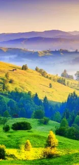 Green hills under a vibrant sunrise with misty mountains in the background.