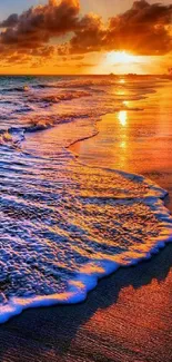 Vibrant orange sunset on a beach with ocean waves.