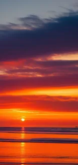 Vibrant sunset over calm beach with colorful sky.