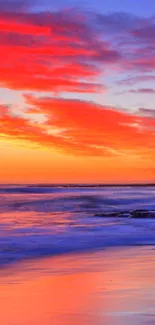 Vibrant sunset at the beach with colorful sky and ocean.