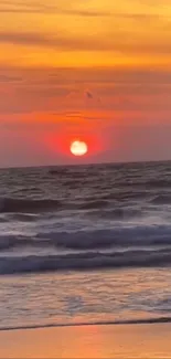 Vibrant sunset over a serene ocean beach.