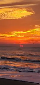 Vibrant orange sunset over a serene beach