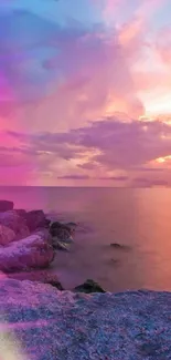 Vibrant sunset beach with rocky shores and colorful sky.