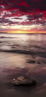 Stunning sunset beach with red clouds and tranquil ocean waves in vibrant colors.