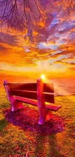 A stunning orange sunset over a bench by the water.