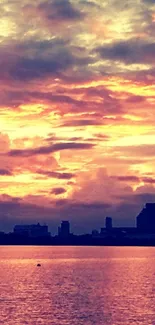 Vibrant sunset over city skyline, reflecting on water.