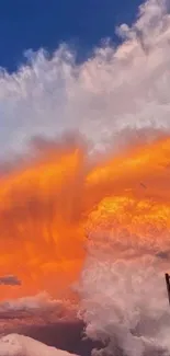 Vibrant orange sunset clouds with blue sky background.