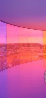 Vibrant pink and orange sunset seen through a glass corridor overlooking a cityscape.